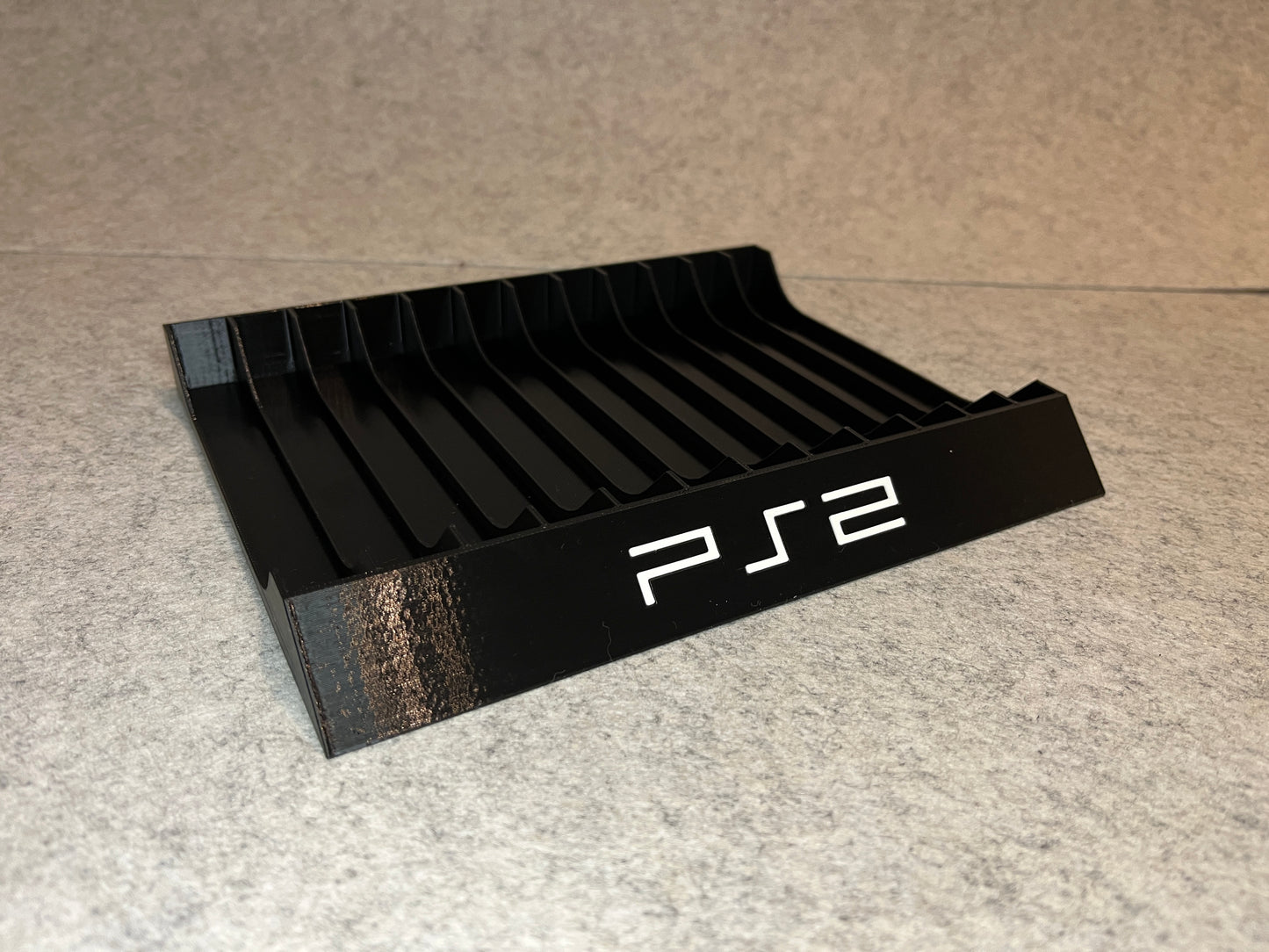Spelställ för 12 PlayStation 2-spel med PS2-loggan