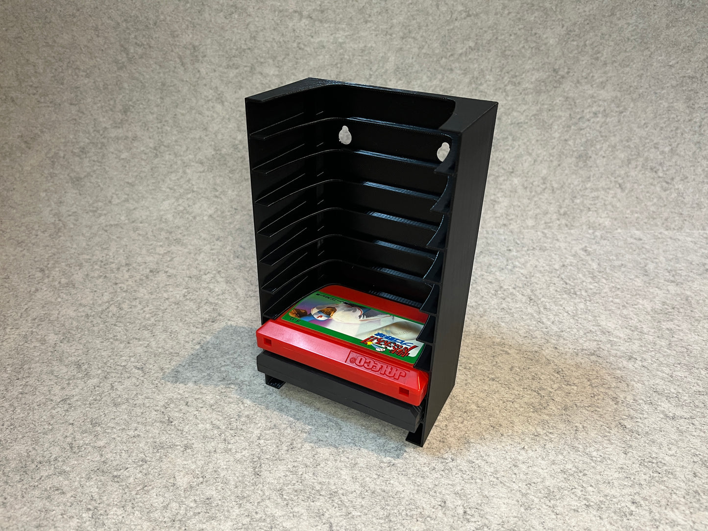 Vägghållare / spelställ för 10 spel till Nintendo Famicom