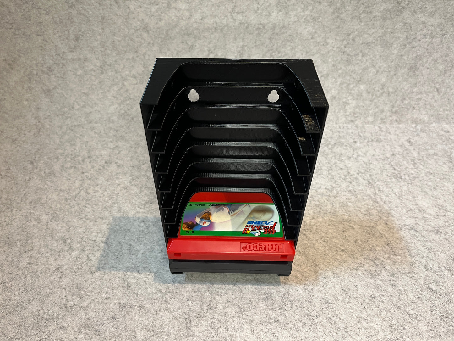 Vägghållare / spelställ för 10 spel till Nintendo Famicom